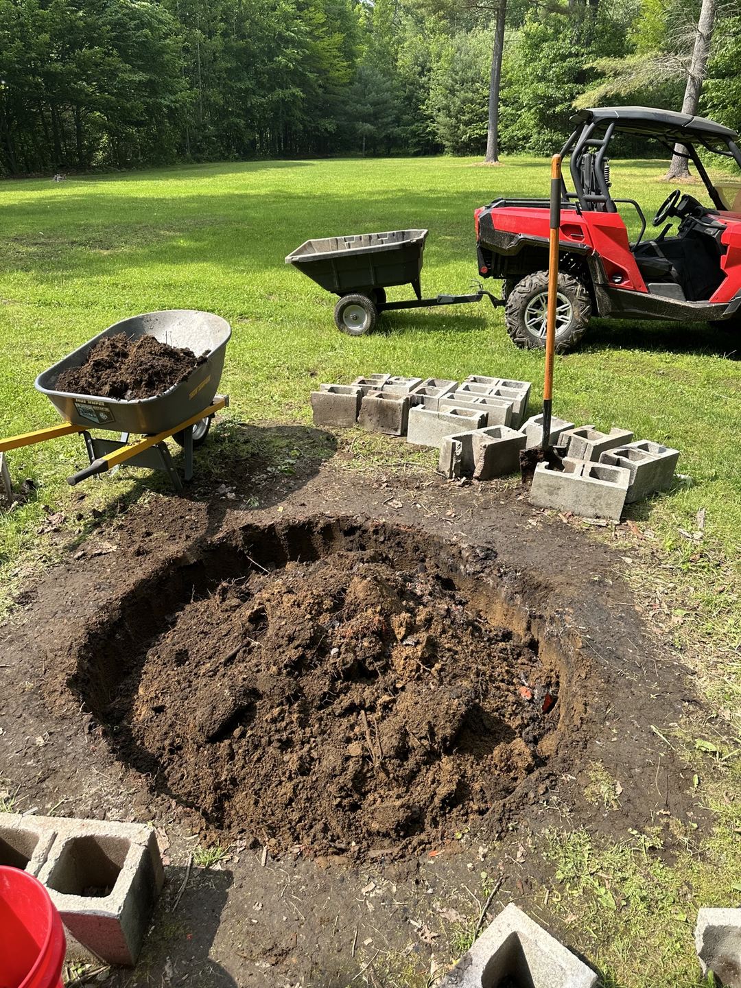 Excavated fire pit area, dug out and marked in the yard