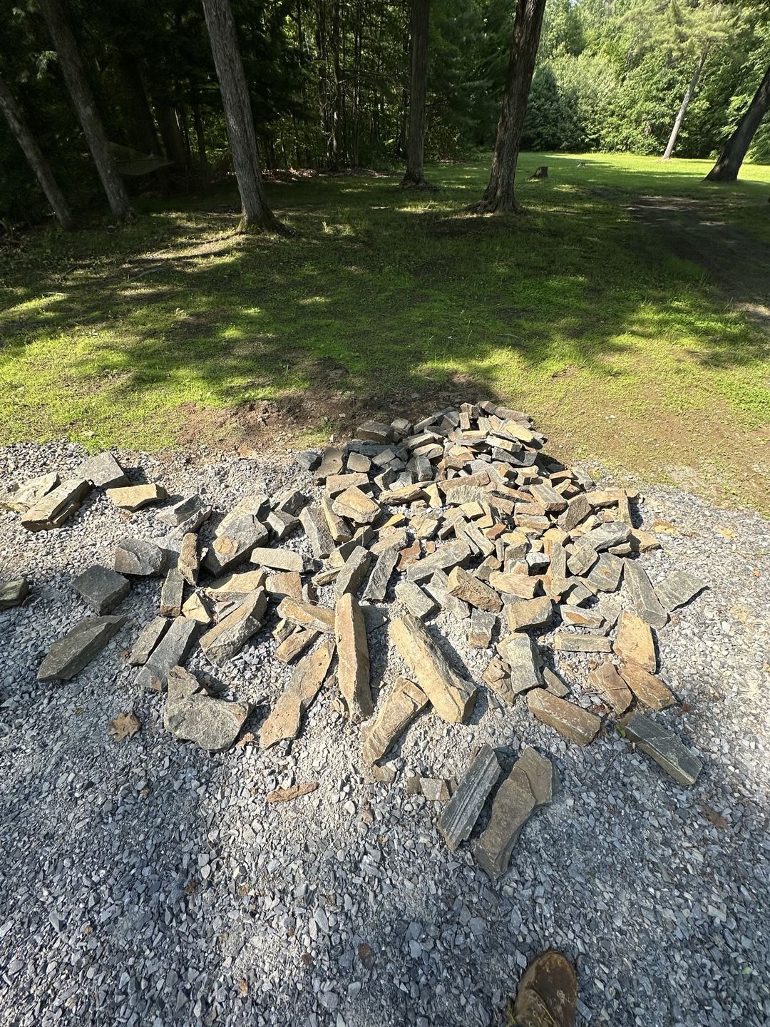Pile of stone for the fire pit on a gravel surface